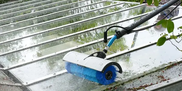 Professionelle Glasdachreinigung mit rotierender Bürste und Wasser für streifenfreie Sauberkeit.